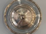 a silver plate with a gold rim on the wall