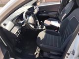 the interior of a car with black seats and a steering wheel