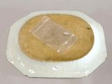 a white plate with a clear plastic cover on it