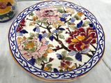 a plate with flowers on it sitting on a table