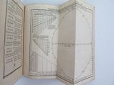 an open book with a drawing of a circle and a line on it