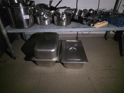 many pots and pans on a table in the kitchen