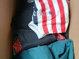 a box full of clothes that is sitting on the floor
