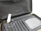 someone is holding a wallet with a cell phone inside of it
