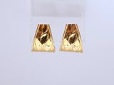 a pair of gold earrings on a white background