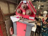 a red machine that is sitting in a garage