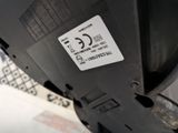 a close up of a parking meter with a sticker on it