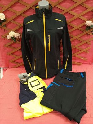 black and yellow jacket and pants on a bed with a pink blanket