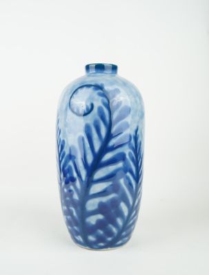 a blue and white vase sitting on a white surface