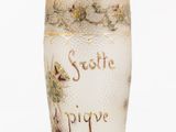 a white vase with a gold and white design on it