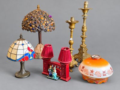 three different lamps and a lamp shade on a table