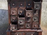 a wooden cabinet that has many drawers on it