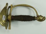 a sword with a gold handle on a white surface
