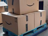 boxes stacked on a pallet in a warehouse with a bicycle in the background