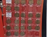 a red binder with a bunch of coins inside of it