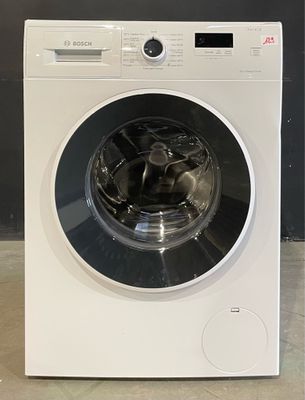 une photo d'une machine à laver blanche posée sur un plan de travail