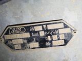 a close up of a metal sign on the side of a building