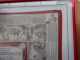 a picture of a picture of an old newspaper in a red frame