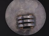 a picture of a metal object on a black surface