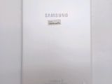 the back of a white samsung tablet with a sticker on it