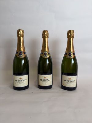 three bottles of champagne sitting next to each other on a table