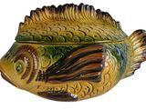 a ceramic fish shaped container on a white background