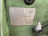 a metal plate on the side of a green machine