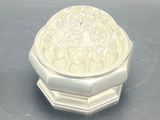 a small white box with a lid on a table