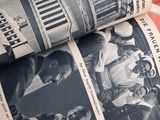 a person reading a newspaper with pictures on it