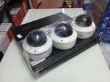 three cameras sitting on top of a table in a store