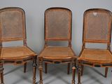 three antique cane back chairs with cane backs and wooden legs