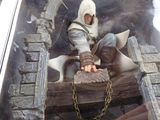a figurine of a man sitting on a wooden structure