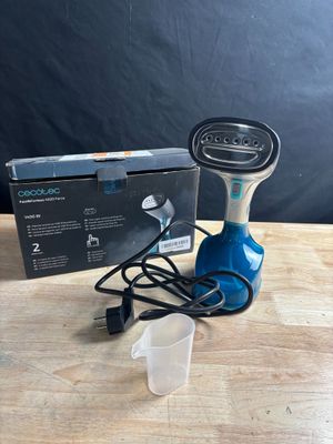 a close up of a corded device on a table next to a box