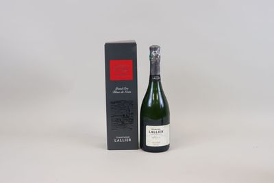 the bottle of wine is next to the box on the table
