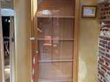 a glass door with a sign on it in the corner of a room