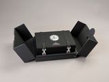 a black case with a clock on it sitting on a table