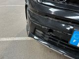 a black car with a blue license plate on it