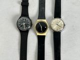 three different watches sitting on top of a white surface