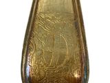 a gold spoon with a picture of a ship on it