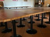 a long table in the middle of a room with chairs