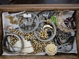 a wooden box filled with assorted jewelry on a table