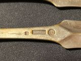 three spoons that are sitting on a table
