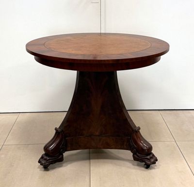 a round table with a wooden top on a tiled floor