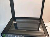 an image of a printer sitting on top of a desk next to a printer