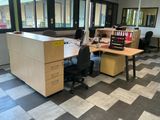 a desk with two chairs and a computer on it in an office