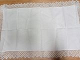 a close up of a piece of white linen on a wooden table