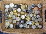 a wicker basket filled with lots of different types of watches