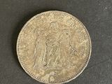 a close up of a coin on a black surface