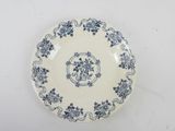 a blue and white plate with flowers on it