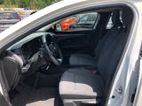 the interior of a car with the door open and the driver ' s seat down